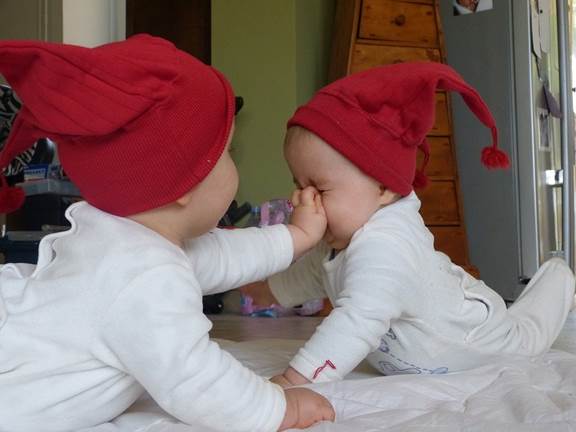 baby twins in red caps