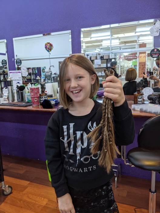 accomplishment girl donates hair